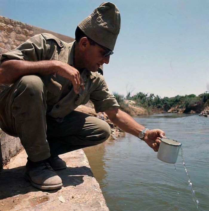 "An Israeli Soldier Drinking a Glass of Water from the Jordan River After the Six-Day War in July 1967."