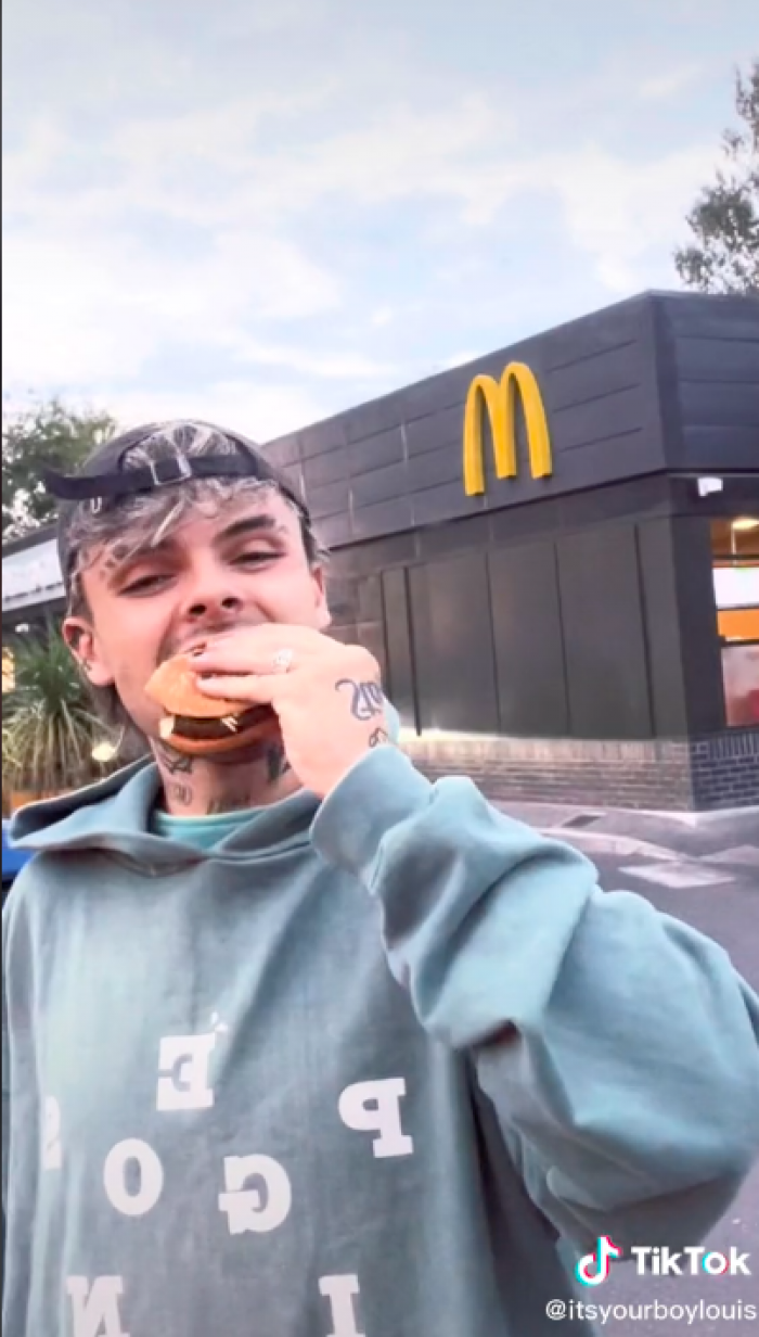 Here you can see him very excited to take a bite of a vegan burger with regular cheese.