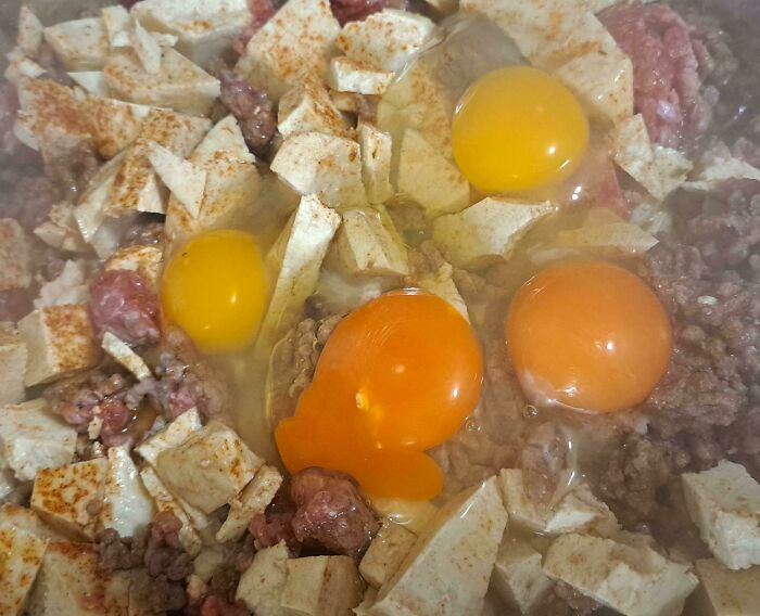 "Egg Yolks Before And After Adding Red Pepper To Their Food"