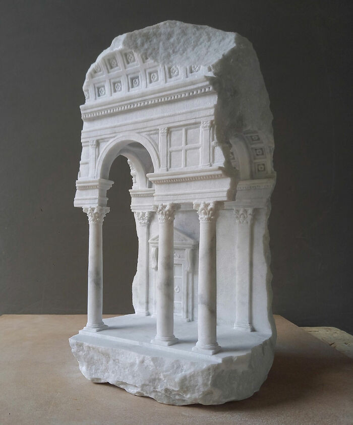 Miniature architectural stone work titled “A Light In Dark Places” with lighting.