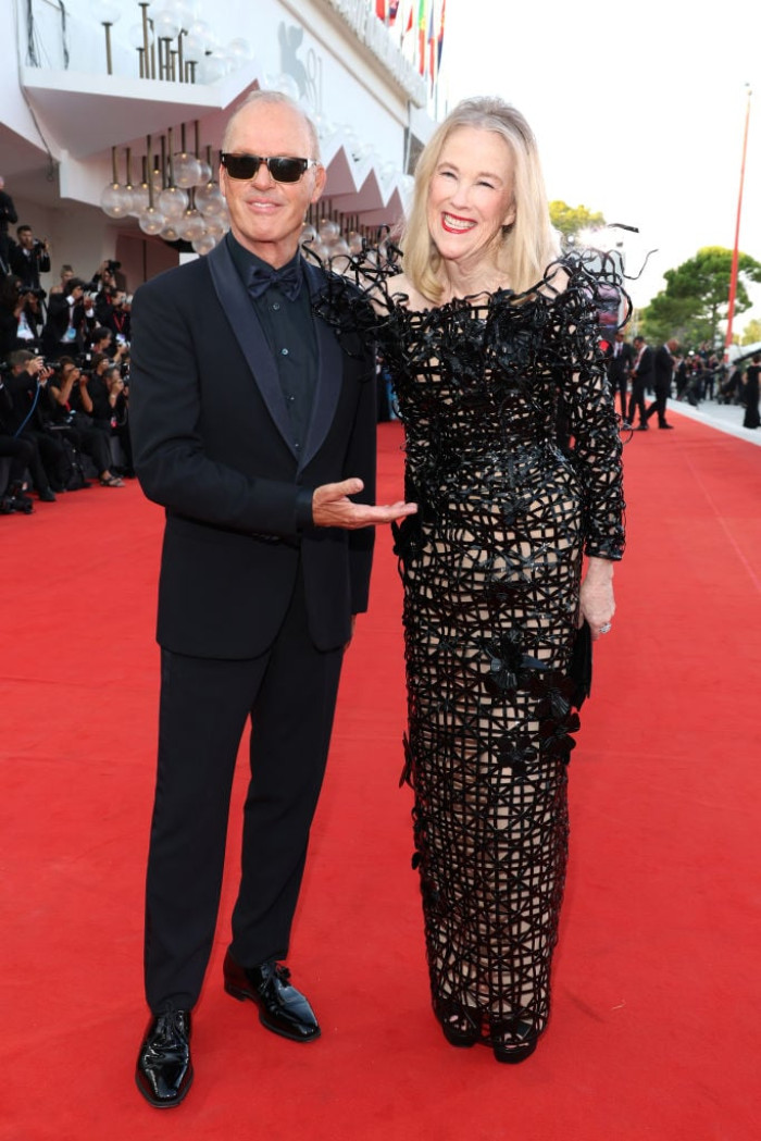 Michael Keaton and Catherine O'Hara smiling together at a film event