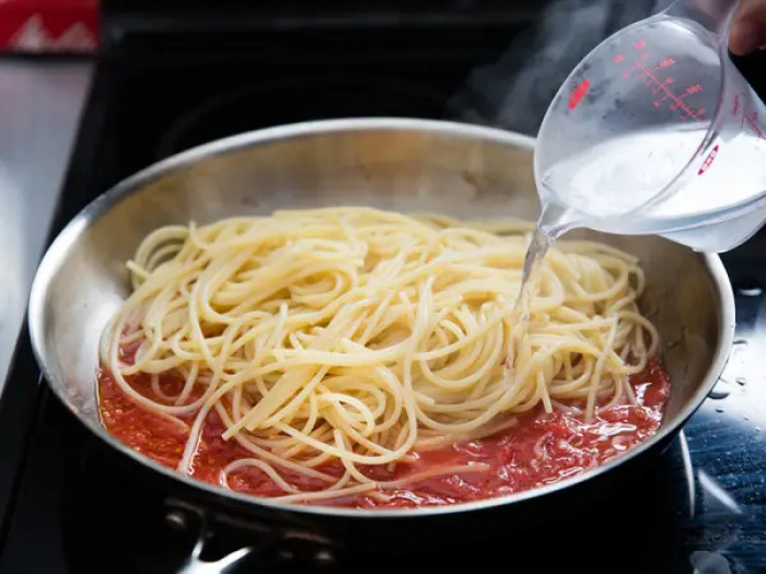 29. Once the pasta is almost al dente, finish cooking it in the sauce while adding some of the accumulated pasta water.