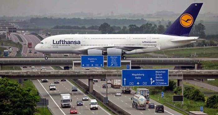 "An Actual Plane Landing At Leipzig Airport As It Crosses Over The Autobahn"