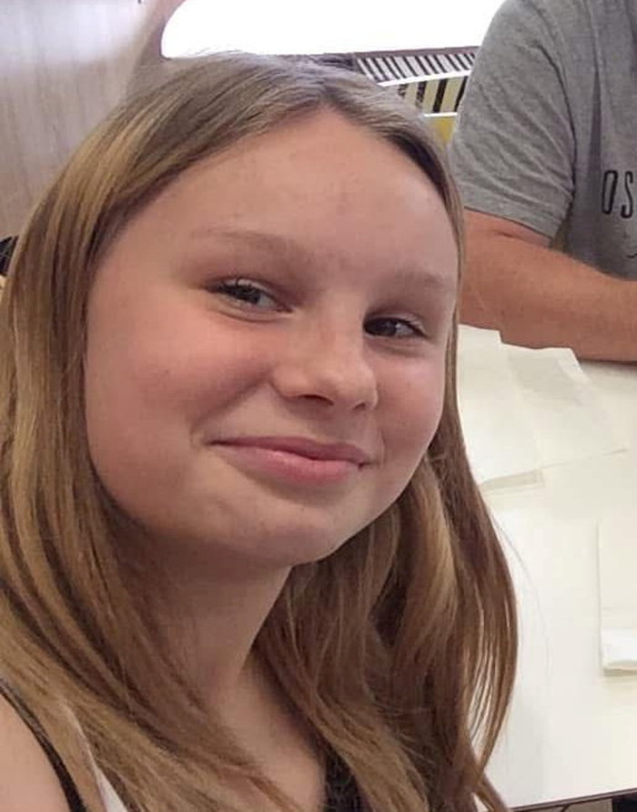 Teenager receiving medical attention, doctors near hospital bed during neurological emergency