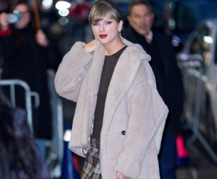 Blake Lively and Taylor Swift smiling together, hinting at supportive friendship.