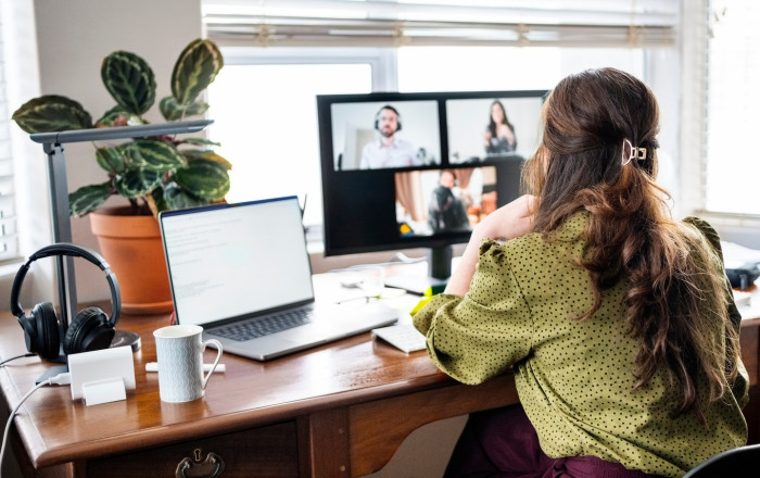 Office workers using laptops remotely during severe weather, referencing wage entitlements and closures.