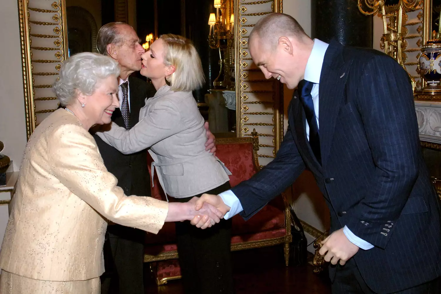 A royal handshake for Mike Tindall as Queen Elizabeth and Prince Philip greet him and Zara Phillips at Buckingham Palace. Royals and rugby—what a winning combination!