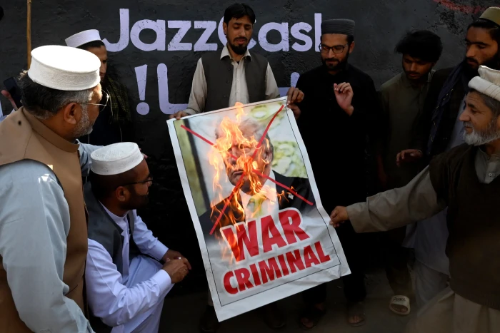 American flags and lawmakers discussing Trump’s Iran airstrikes amid rising tensions