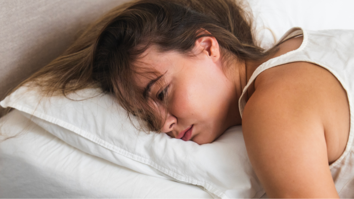 Bed sheet with perspiration stains, warning about night sweats and cancer symptoms