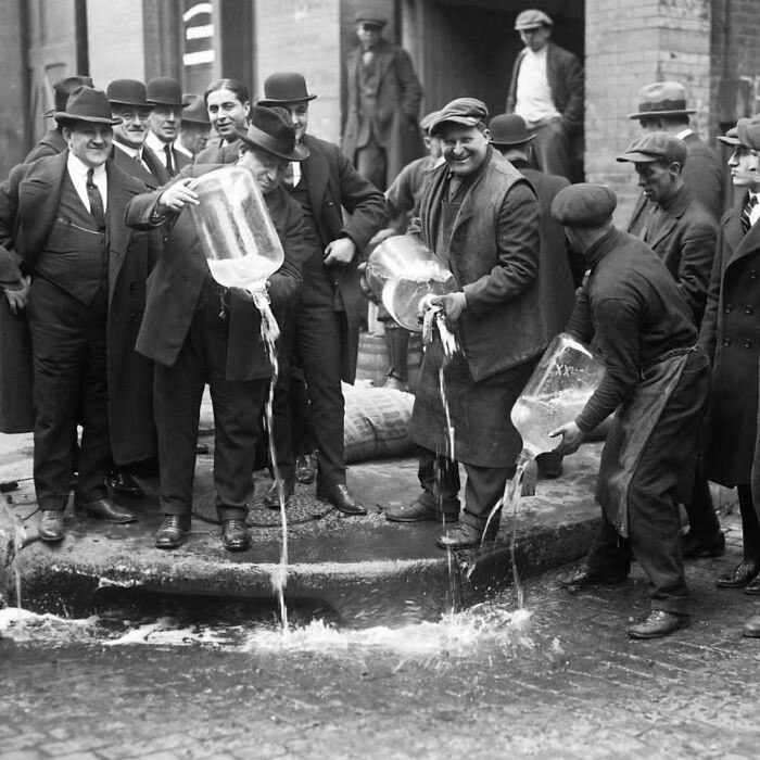 "Policeman Dumping Alcohol Into The Gutter, New York 1922"