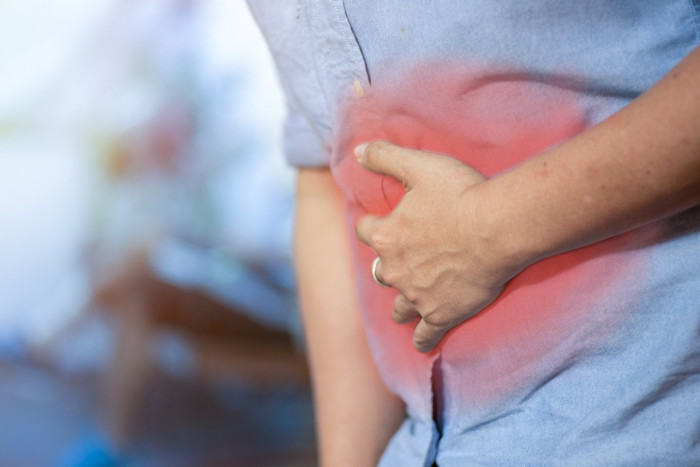 Man undergoing colon cancer screening during routine check-up, news headline style.