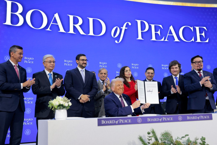 Global map backdrop showing international reaction to Trump’s Board of Peace initiative.