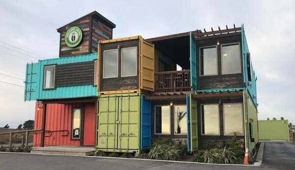 23. A coffee shop built out of brightly colored shipping containers.