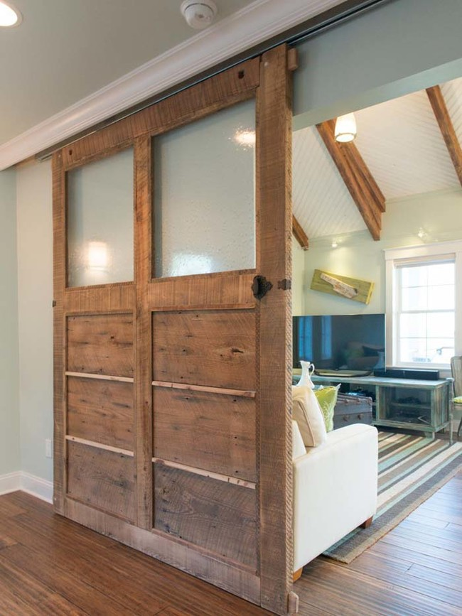 3. With proficient DIY skills, you can craft this sliding door from reclaimed wood.