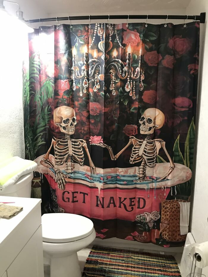 "This Shower Curtain Has A Hilarious Design Of A Demented Cat Rising Out Of The Sea And Slurping Ramen"