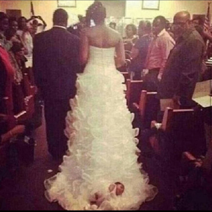 2. “Bride ties her 1-month-old baby to the back of her wedding dress.”