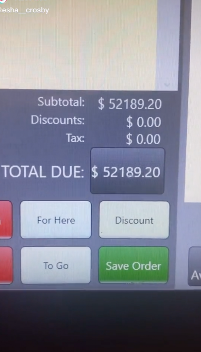 The barista shows off the total screen, which displays an amount due of over $50,000.