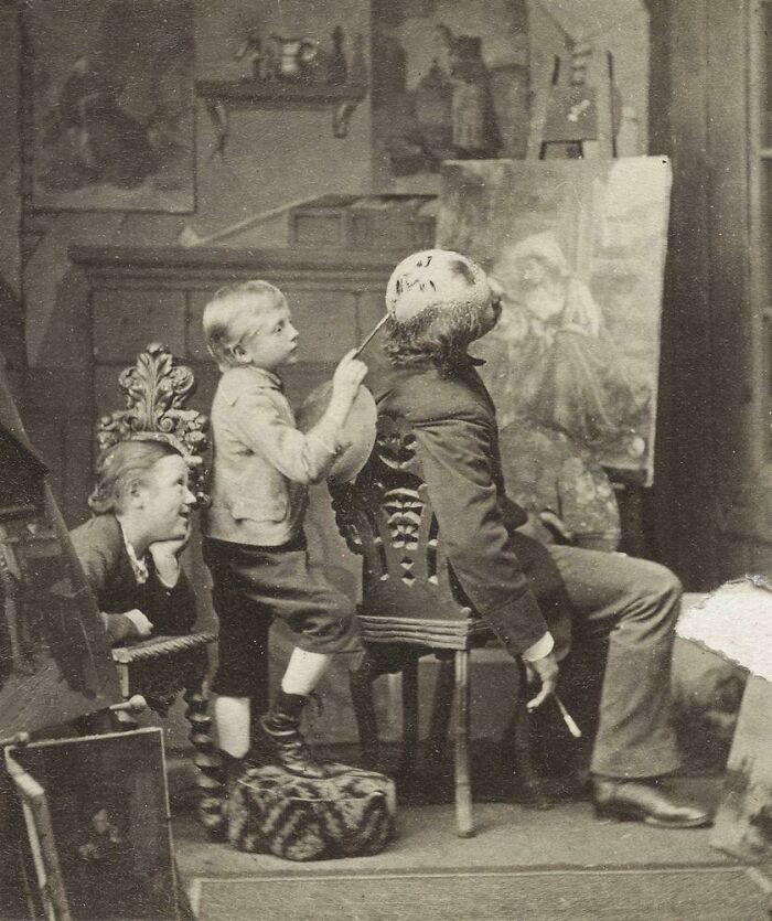 "Boy Painting A Face On The Back Of His Father’s Bald Head, 1877"