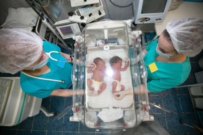 1. “Holding a pair of dying twin boys so they wouldn’t die alone.