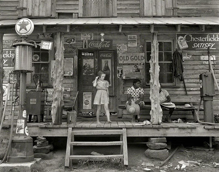 “Daughter of a white tobacco sharecropper at the country store. Person County, North Carolina.” By Dorothea Lange - July, 1939.
