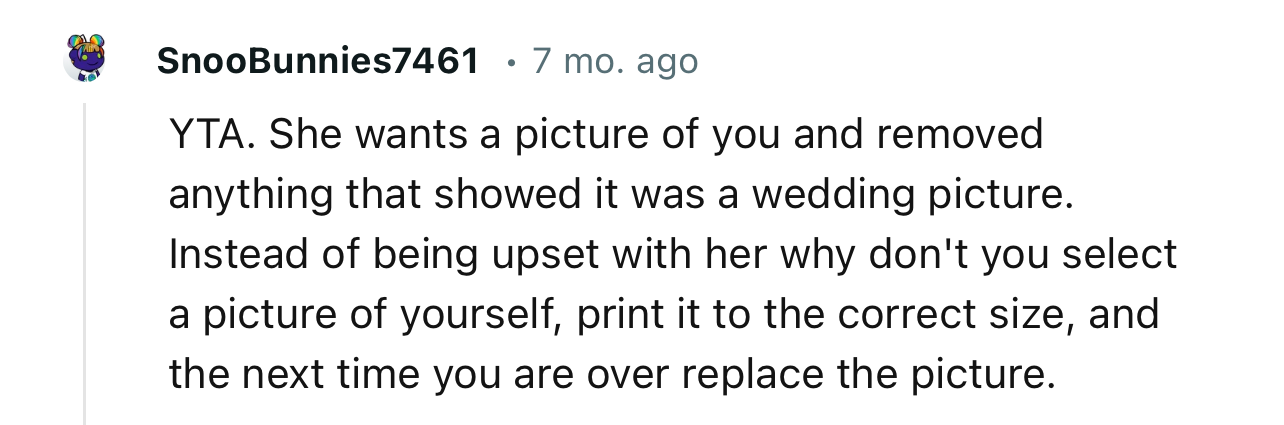 “YTA. She wants a picture of you and removed anything that showed it was a wedding picture.”