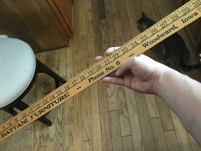 22. This yardstick found in someone's attic is old enough to have a one-digit phone number