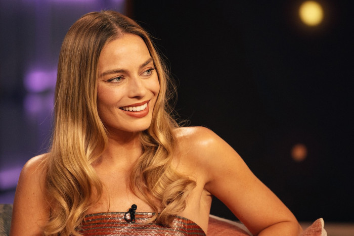 Jacob Elordi and Margot Robbie on set, discussing their upcoming movie together