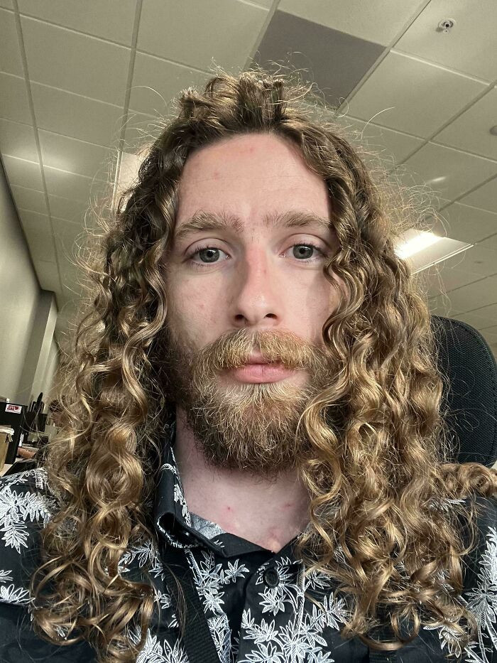 Man with long curly hair air-drying, casual discussion about wild curls