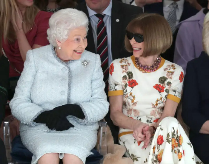 29. Sitting beside Anna Wintour as they view Richard Quinn's runway show