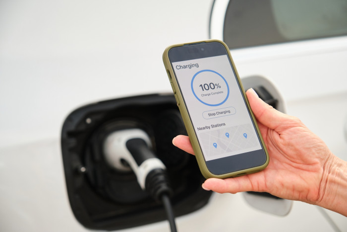 Electric vehicle charging at a standard home outlet, discussing costs and options