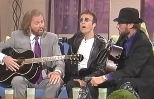 The Bee Gees Had Acoustic Guitars Ready. Then Barry Gibb Turned a 1998 TV Spot Into an A Cappella Moment