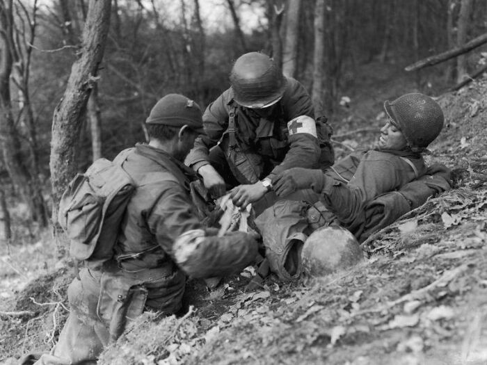 "Corpsmen of the U.S. 4th Infantry Division Treat a Wounded Man in the Wehebachtal Valley in the Hurtgenwald, November 18, 1944, Rhineland, Germany."