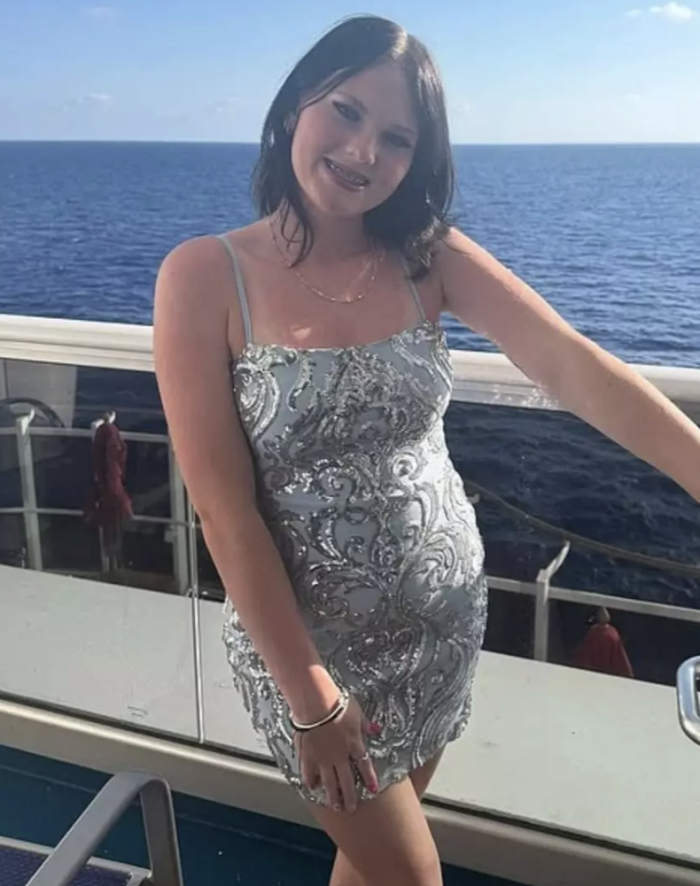 Community members gather for a memorial vigil on a cruise ship deck