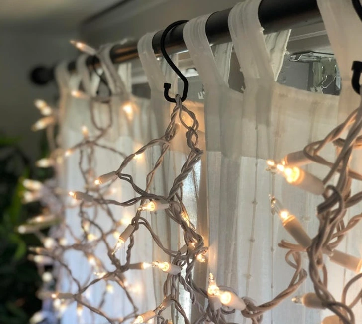7. “Shower curtain hooks work well for hanging holiday lights on curtain rods.”