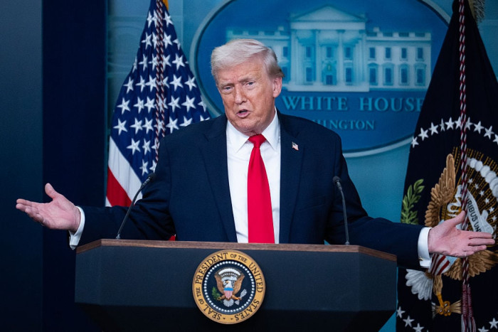 Donald Trump speaking at a news event, discussing large $2,000 payment plan