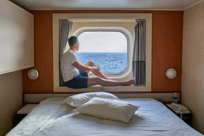 Person holding head, symbolizing balance disorders and cruise travel health risks
