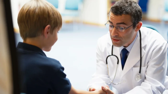 Close-up of child showing subtle facial tic movements, early Tourette’s signs