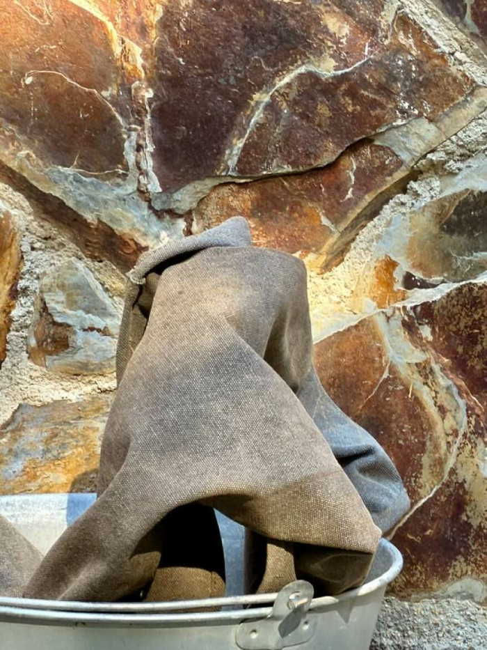 'Do You See The Back Of A Man Wearing A Long Cloak With A Hood, Trying To Climb Out Of The Bucket?'