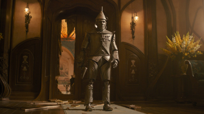 His future unfolds inside a metal shell, a permanent reminder of a heart that vanished and a life rewritten. Every glimpse of the Tin Man becomes a quiet echo of who Boq used to be.