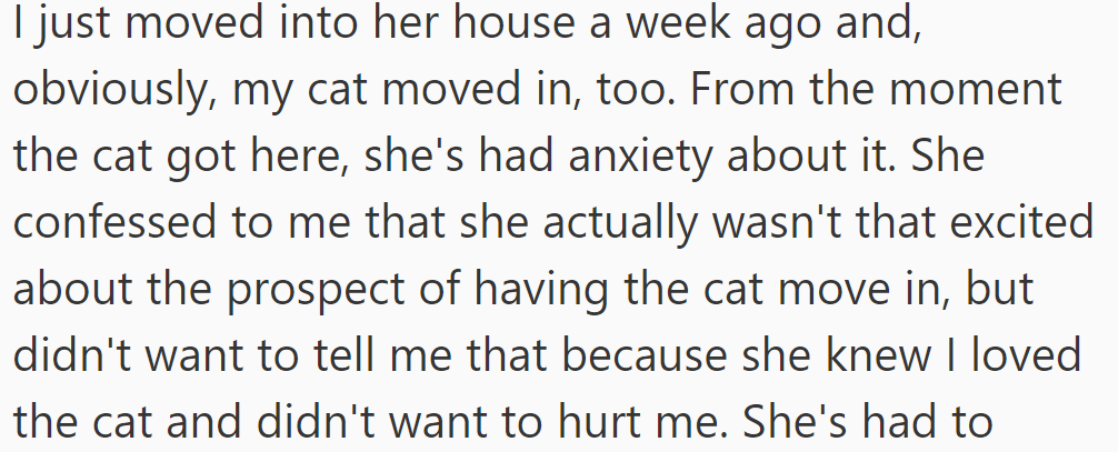 Since moving in together last week, her anxiety about his cat's presence has surfaced despite initial excitement.