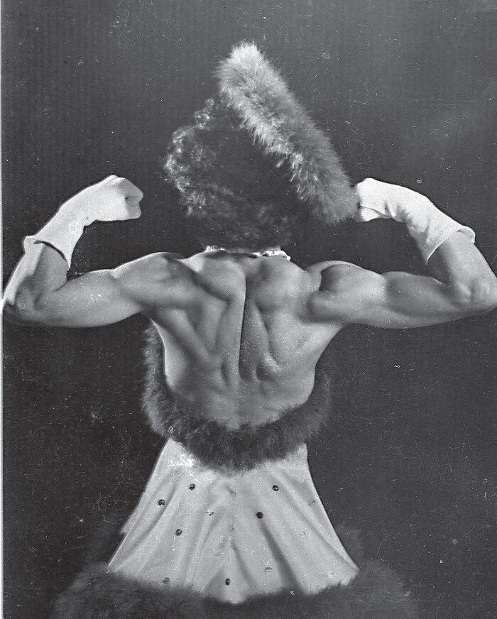 Circus performer Ethel Hart poses confidently, revealing her back in a candid 1940s photo.