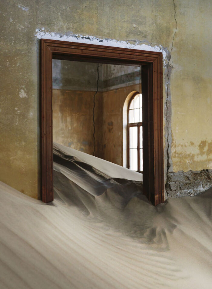 17. Desert sand flows through the door like a slow, unstoppable tide