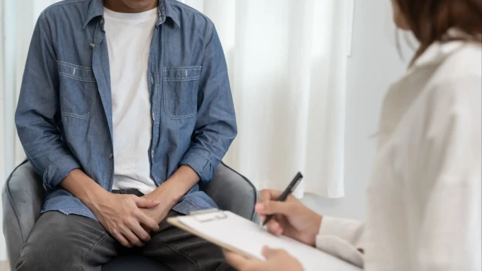 Doctor discussing urinary symptoms with an older man, prostate cancer warning signs