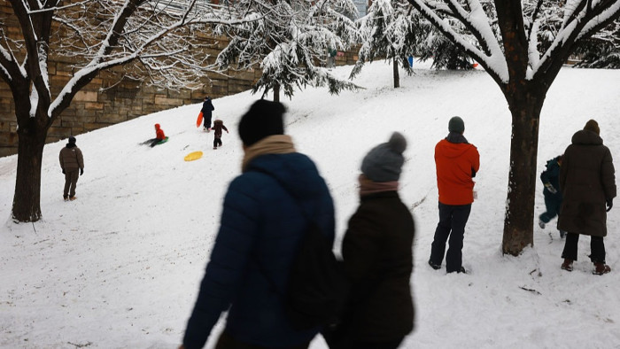 Snowy road scene in lake effect snow region, travel hazards and whiteout conditions