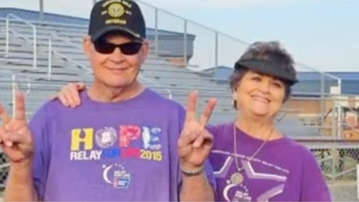 Couple holding hands, smiling, sharing survival story after multiple cancer diagnoses