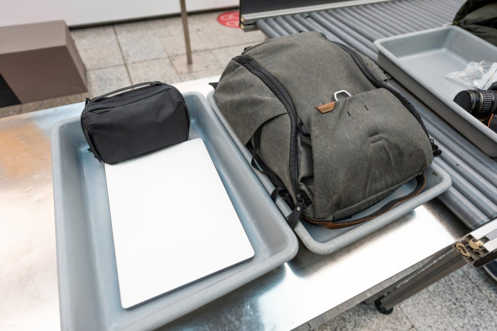 TSA security checkpoint signs warn travelers of longer airport screening wait times.