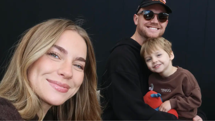 Emilie Kiser grieving, holding a child’s photo after pool accident tragedy