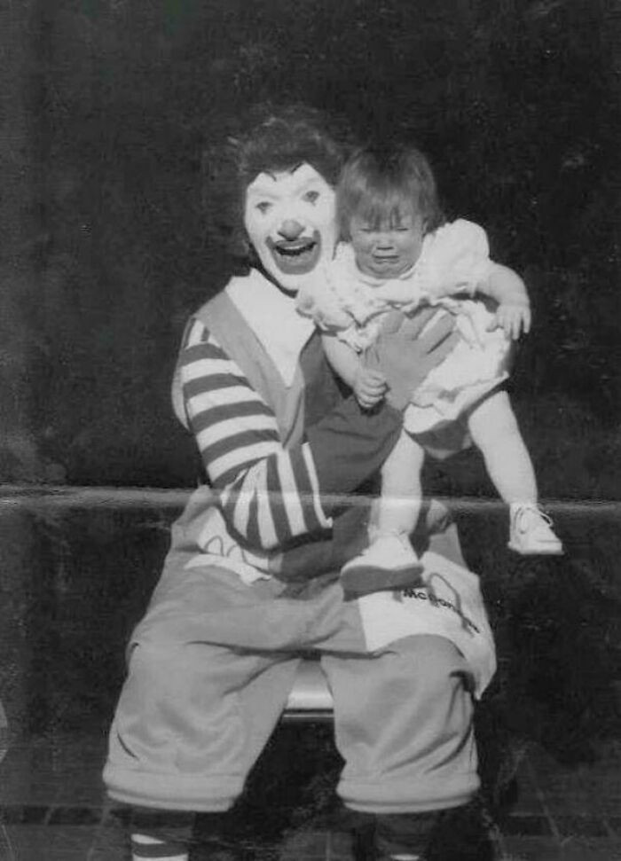 An early take on Ronald McDonald was captured in a photo next to a visibly upset baby.