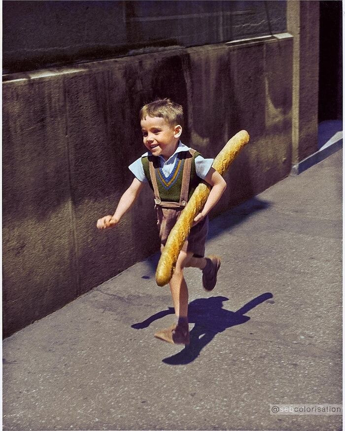 12. A French Boy Running Down A Street With A Baguette Photographed By French Photographer Willy Ronis In 1952