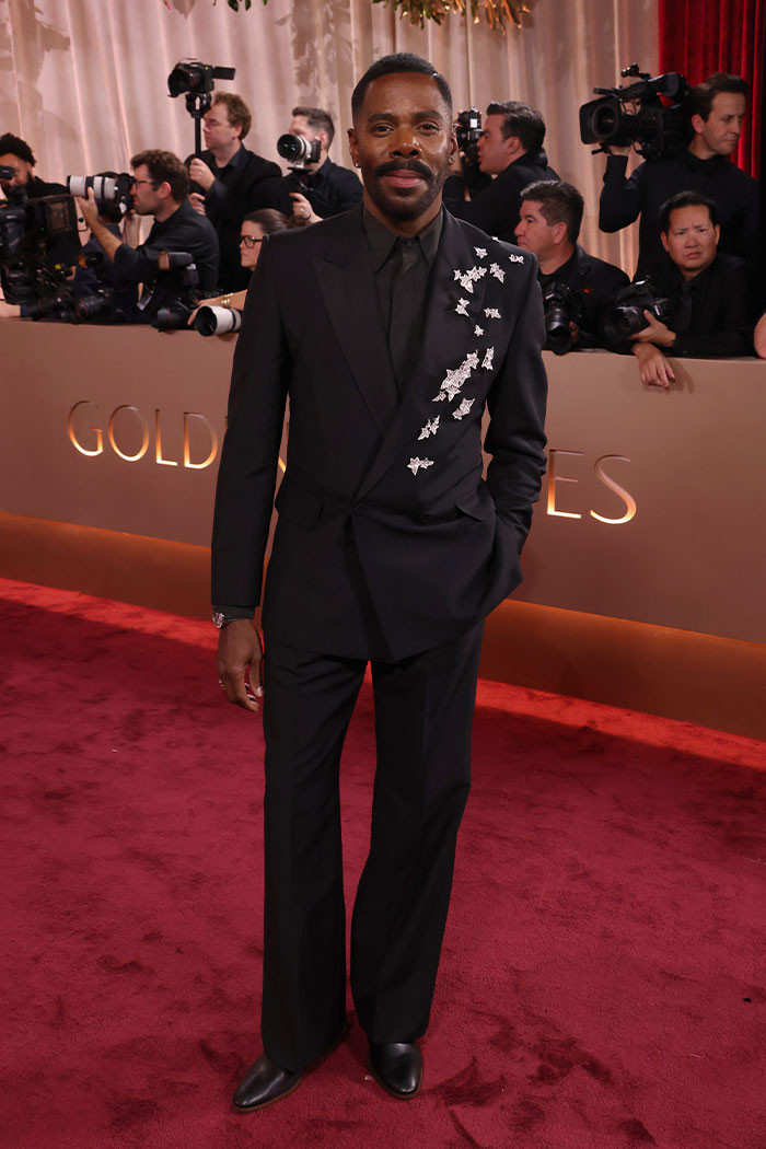 Colman Domingo stood out in a sleek custom Valentino black suit, accented by subtle silver leaf details and finished with a matching shirt and tie.